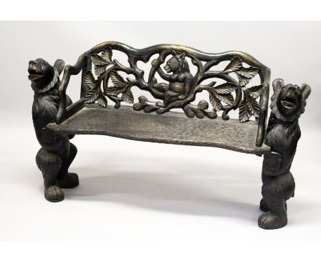 A "BLACK FOREST" CARVED WOOD BENCH SEAT, the naturalistically carved seat with a bear being supported by a bear to each end 5