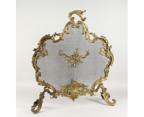 A GOOD FRENCH ORMOLU AND MESH FIRESCREEN, with acanthus scrolls and shell. 31ins high.
