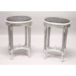 A PAIR OF FRENCH STYLE CARVED AND SILVERED WOOD LAMP TABLES, with oval marble tops. 2ft 4ins high