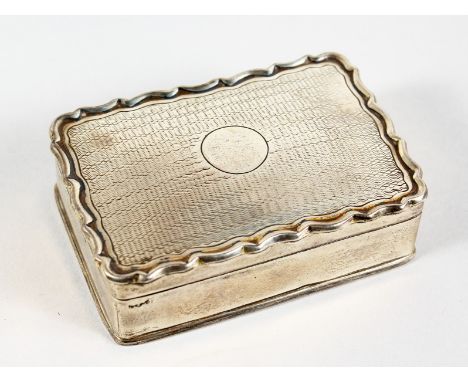 A RECTANGULAR SILVER BOX with engine turned top. 3ins long.  London 1906.