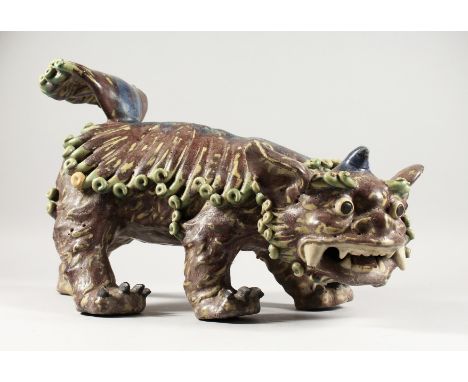 A LARGE ORIENTAL CERAMIC SHI DOG. 19ins long.