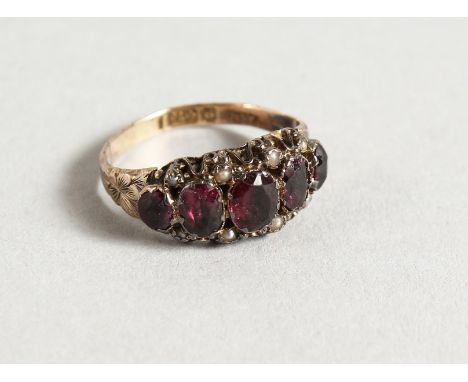 AN 18CT RUBY AND SEED PEARL SET FIVE-STONE RING.