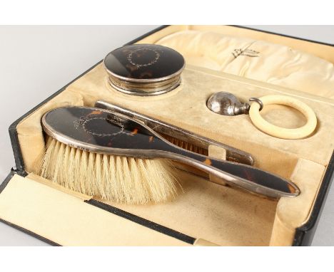 A VICTORIAN TORTOISESHELL AND SILVER BRUSH, POWDER POT, COMB AND SILVER TEETHING RING, in a fitted case. Birmingham 1899.  FI