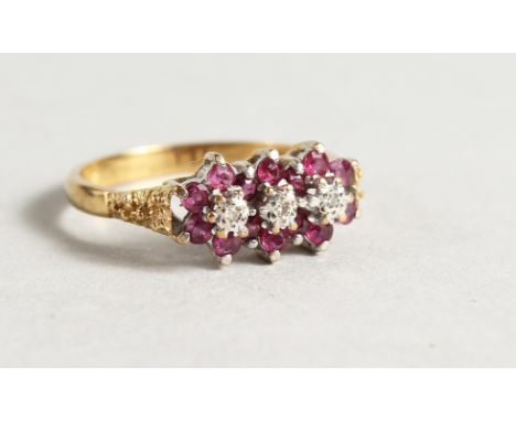 AN 18CT GOLD RUBY AND DIAMOND TRIPLE FLOWER HEAD RING.