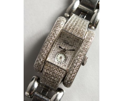 A VERY GOOD LADIES DIAMOND SET CHOPARD "LA STRADA" WRISTWATCH, No. 41/8380 1093723 8357, with spare link in original box.