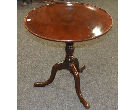 A George III mahogany circular tripod occasional table, the dished top on a turned pedestal and splayed legs, diameter 69cm