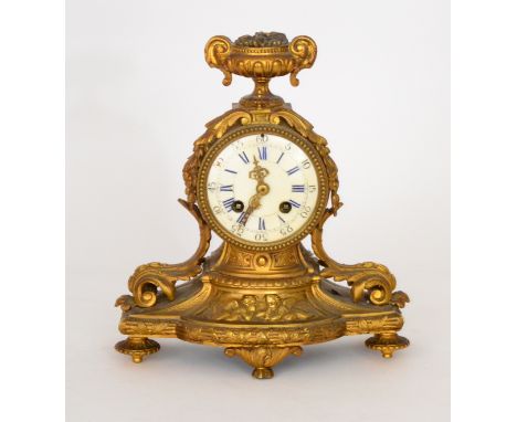 A 19th Century French gilt metal mantle clock with circular white enamelled dial and eight day movement striking on a bell, n