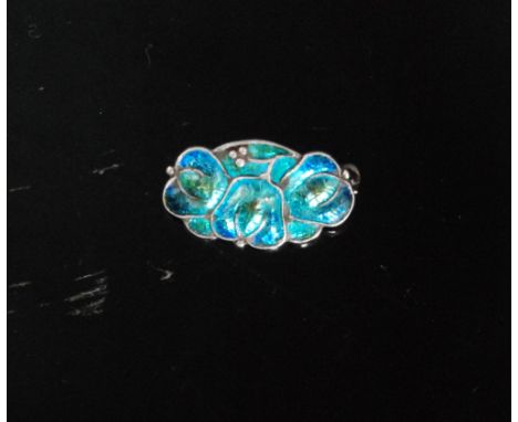 An early 20th Century Arts and Crafts enamelled pin brooch, of shaped rectangular outline designed as three interlinked tulip