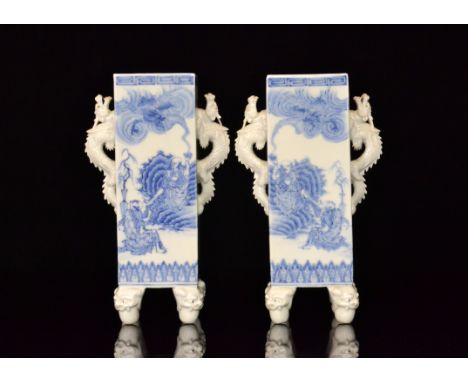 A pair of late 19th Century Japanese vases, each of square form raised to four corner feet modelled as dragon heads with ball