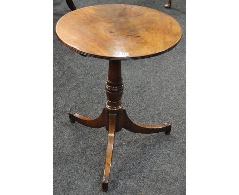 A 19th Century mahogany circular tilt top occasional table with reeded edge top on a turned pedestal and splayed tripod legs,