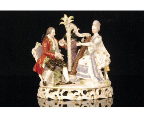 A 19th Century Meissen figural group modelled as a lady harpist seated before an elaborate harp with her male companion holdi