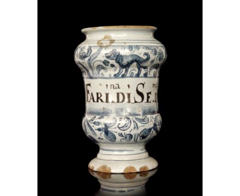 A second quarter of the 17th Century Savona maiolica albarello, of diabolo form and painted in blue and manganese with swayin
