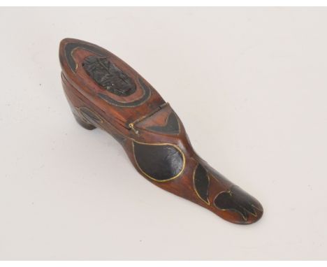 A carved wooden snuff box modelled as a lady's shoe with inlaid brass foliate decoration and a carved oval portrait panel to 