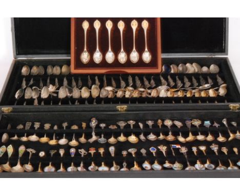 A case containing a approximately 121 silver and low grade silver collectors spoons from across the world, to include many gi