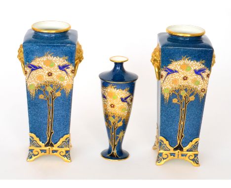 A pair of early 20th Century Royal Worcester vases, each of square form decorated with stylised tall trailing trees with enam