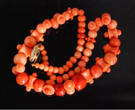 A Victorian coral necklace, the graduated beads alternating with bobbin and circular beads to yellow metal clasp, length 36cm