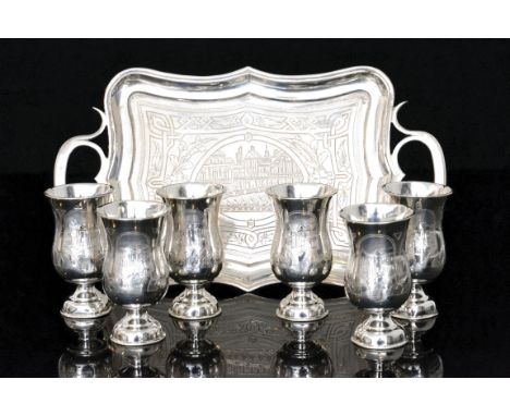 A Russian silver tray and six silver Kiddush cups, each decorated with engraved panels and centred by a cartouche depicting a