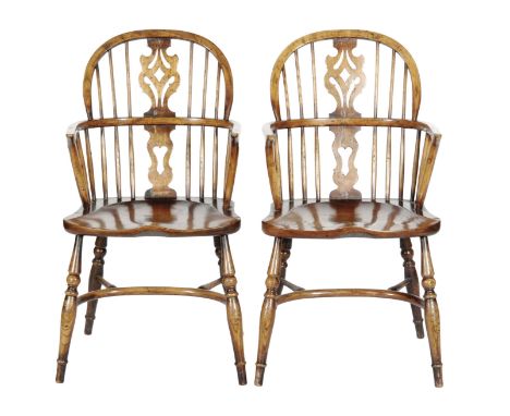 A set of six early 20th Century ash and elm Windsor chairs, comprising two elbow chairs and four standard chairs, the pierced