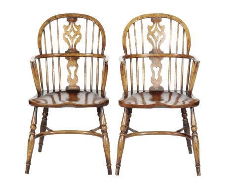 A set of six early 20th Century ash and elm Windsor chairs, comprising two elbow chairs and four standard chairs, the pierced