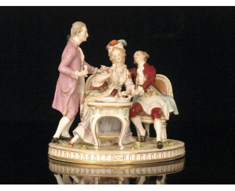 A 19th Century Ludwigsburg Bacchanalian figural group modelled as a seated lady and gentleman sat upon a spoon back sofa, she