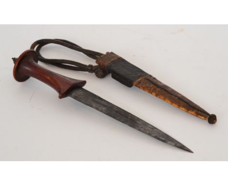 An early 20th Century North African dagger engraved blade in leather and skin covered scabbard, length 30cm