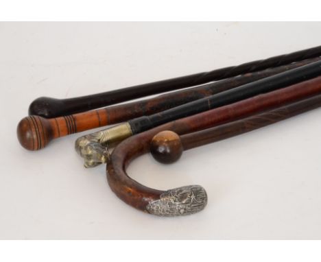 A 19th Century walking stick modelled as a dog's head another silver ended stick and three plain examples (5)