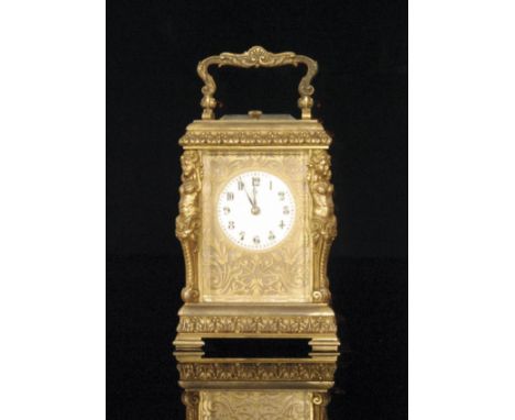 A late 19th Century French gilt metal carriage clock with circular Arabic dial, bordered by a fret cut acanthus leaf panel wi