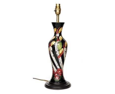 A Moorcroft Pottery lamp base decorated in the La Famille pattern designed by Kerry Goodwin, affixed to a plinth, height 31cm