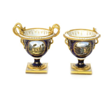 A pair of 19th Century Flight Barr and Barr pedestal urns each decorated with hand painted landscape cartouche panels, the fi