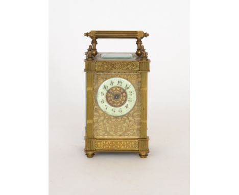 An early 20th Century French brass carriage clock with Arabic dial and pierced foliate panel decoration within a reeded pilla