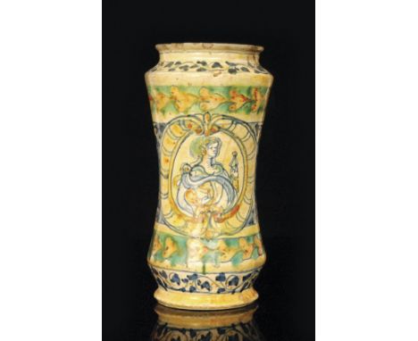 An early 16th Century maiolica albarello, possibly Sienna, of tall waisted form decorated with a central portrait framed with