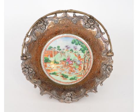 A 19th Century fruit basket, the base with a Chinese famille roundel footed plate decorated with Western figures upon horseba