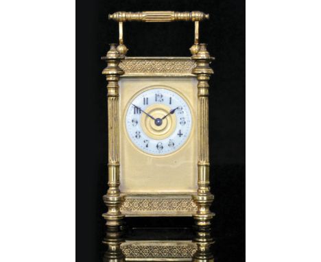 A 19th Century French brass carriage clock with circular Arabic dial and reeded pilasters, matted centre on cone feet, height
