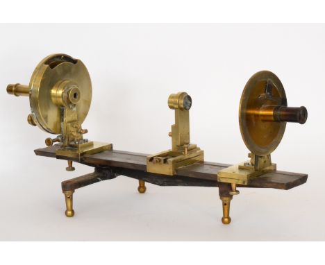 An early 20th Century brass and steel polarimeter on turned feet, length 66cm.

This instrument is used to measure the type a