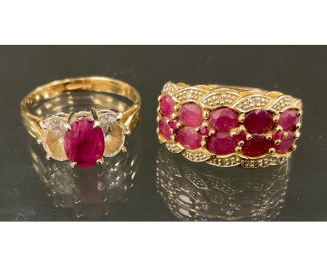 A ruby and diamond cluster ring, with two rows of five oval cut pinky red rubies, between diamond accents, 9ct gold shank, si