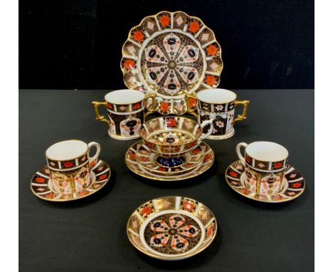 Royal Crown Derby - a pair of 1128 Old Imari pattern coffee cans and saucers, another saucer, a tea cup and saucer, wavy rim 