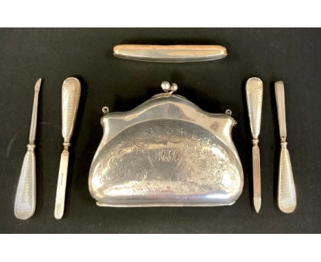 A George V silver evening purse, leather liner, G Norman, Birmingham 1918, 124g gross;  a five piece silver mounted vanity na