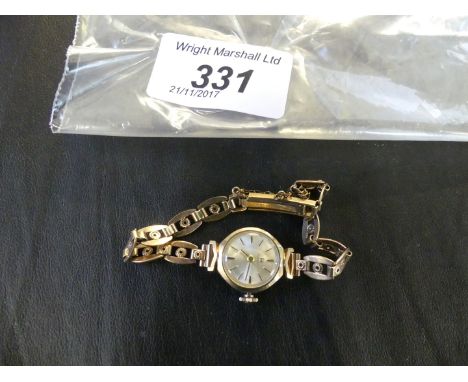 A ladies Tissot, 9 K gold wristwatch, the silvered dial with chainwork strap.