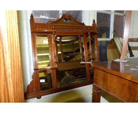 An early 20th Century walnut framed over mantel mirror.