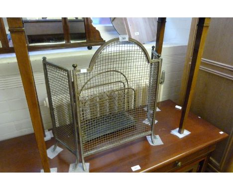 An early 20th Century brass framed fire screen, having mesh panel, together with a two tier magazine rack.