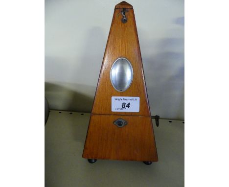 A 20th Century Metronome in stained wooden case, 23cm high.