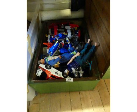 A wooden trunk containing various Action Man and other children's toys, also a quantity of assorted toy vehicles.