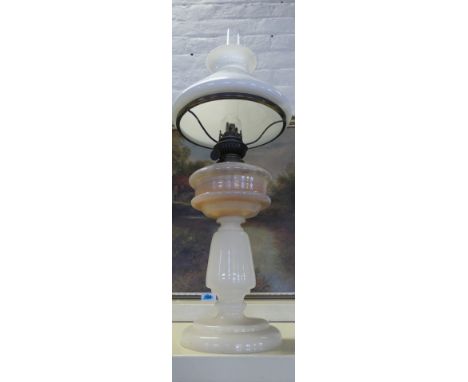 An early 20th Century oil lamp with opaque glass body.