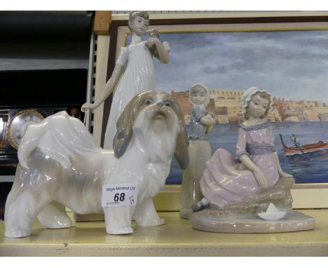 A collection of Nao and Lladro figures, comprising lady with puppy, further terrier and two Nao figures of young girls, large