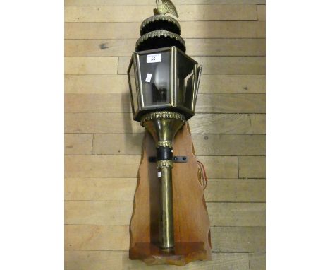 A 20th Century coach type lamp with eagle mount and wooden back board, 74cm high 