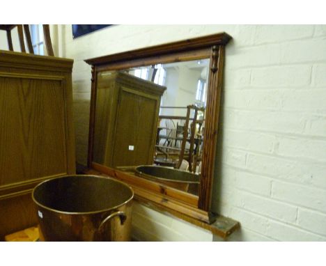 A modern pine bevelled edged framed over mantel mirror.