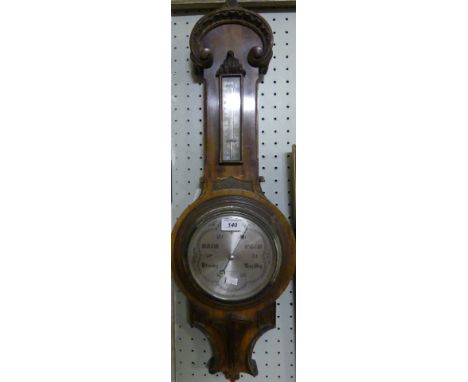 An early 20th Century aneroid barometer/thermometer in American walnut case, bearing retailers mark 'Chadburns Ltd of Liverpo