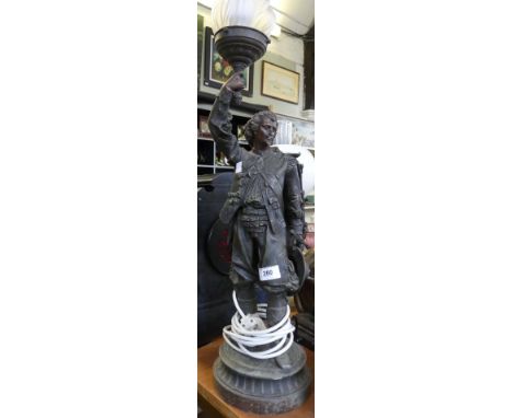 A large bronzed spelter table lamp, formed as a cavalier, fitted with flame shaped glass shade.