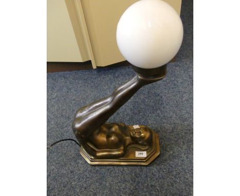 A modern Art Deco style bronzed resin table lamp in the form of a female gymnast.