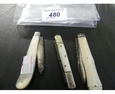 Two silver bladed and mother of pearl handled folding pocket knives, together with one other example.